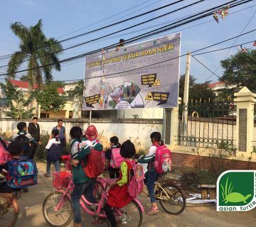 Children leaving school stop to look at the new Rafetus signboard